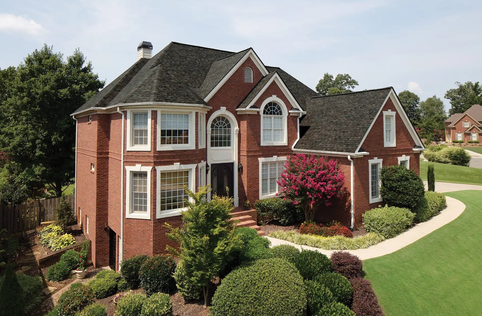 Professional New Jersey home roofing contractors installing shingles on residential house with safety equipment and quality materials